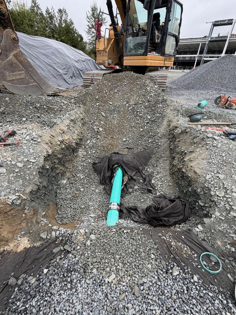 New PVC service pipe bedded in a trench